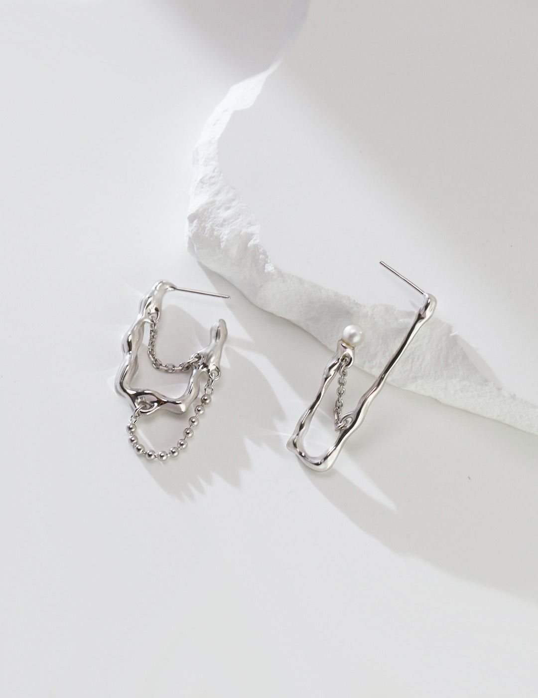 Handmade abstract silver asymmetrical earrings featuring modern and edgy abstract shapes and lines, made with high-quality sterling silver."