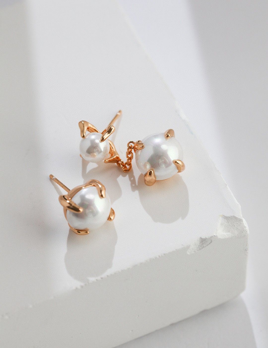 Close-up of Pure Pearl Elegance handcrafted pearl earrings, featuring lustrous white pearls set in a sterling silver or gold-plated backing. The earrings have a classic design and embody timeless elegance, making them a versatile accessory for any occasion.