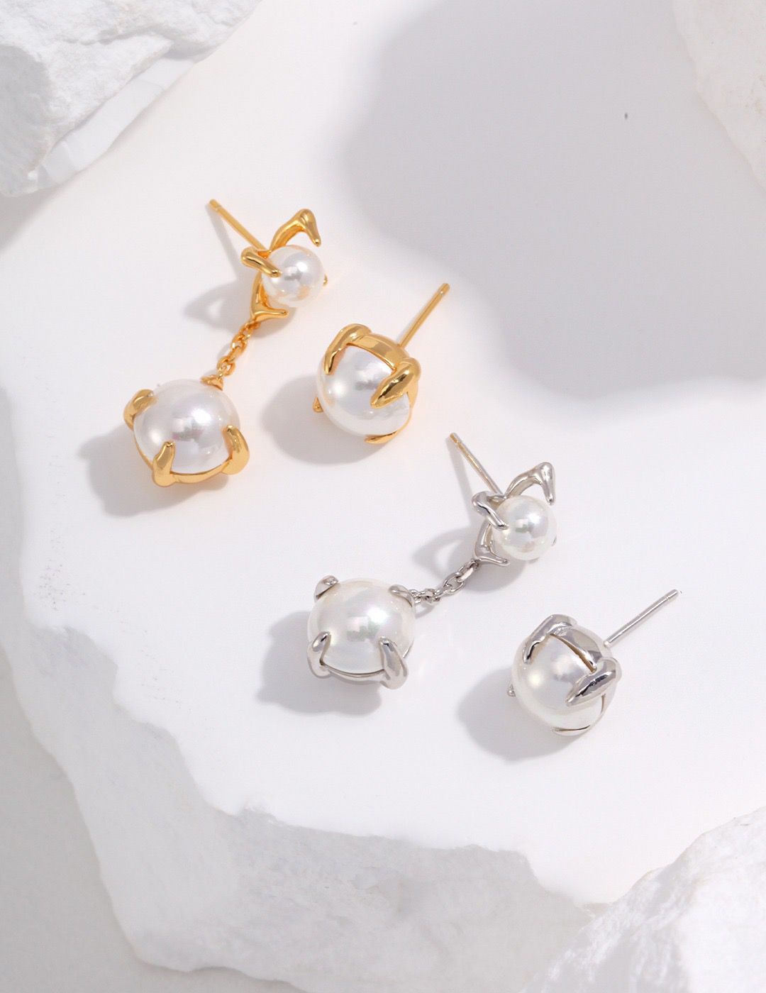 Close-up of Pure Pearl Elegance handcrafted pearl earrings, featuring lustrous white pearls set in a sterling silver or gold-plated backing. The earrings have a classic design and embody timeless elegance, making them a versatile accessory for any occasion.